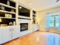 Bright living room features a fireplace with built-in shelving and cabinets for storage and display at 4638 Villa Chase Ne Dr, Marietta, GA 30068