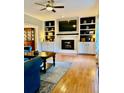 Cozy living room featuring a fireplace with built-in shelving and cabinets for storage and display at 4638 Villa Chase Ne Dr, Marietta, GA 30068