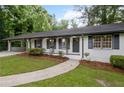 Close-up of a brick home with black shutters and well-manicured landscaping at 5414 Iris Sw Dr, Mableton, GA 30126