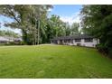 Attractive home featuring a lush lawn and mature trees offering privacy at 5414 Iris Sw Dr, Mableton, GA 30126