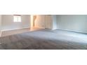 Spacious living room featuring new carpet and neutral paint, creating a welcoming atmosphere at 5618 Stonington Trace Pkwy, Stone Mountain, GA 30087