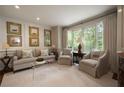 Bright and airy living room featuring a neutral color palette, ample seating, and natural light at 1860 Anjaco Nw Rd, Atlanta, GA 30309