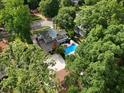 An aerial view showcasing a private pool, lush landscaping, and mature trees surrounding the property at 1036 Oxford Ne Rd, Atlanta, GA 30306