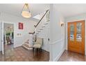 Bright foyer featuring hardwood floors, staircase, and a stylish wooden door with stained-glass detailing at 1036 Oxford Ne Rd, Atlanta, GA 30306