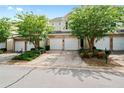 Townhome featuring multi-car garages, manicured landscaping, and partial brick facade at 125 Flatwood, Marietta, GA 30066