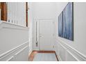 Bright foyer with hardwood floors, white trim, and staircase, creating a welcoming entrance at 125 Flatwood Trail, Marietta, GA 30066