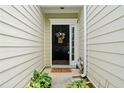 Charming front entrance featuring a black door, decorative wreath, and a 'Welcome' mat at 125 Flatwood Trail, Marietta, GA 30066