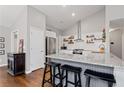 Open concept kitchen with granite countertops, stainless steel appliances, and modern finishes at 192 Sandhurst Ct, Suwanee, GA 30024