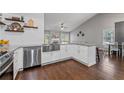 Bright kitchen featuring stainless steel appliances, farmhouse sink, and granite countertops at 192 Sandhurst Ct, Suwanee, GA 30024