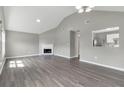 Spacious living room featuring a fireplace, open view to the kitchen, and wood-look flooring at 2022 Patterson Park Dr, Lawrenceville, GA 30044