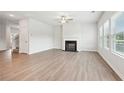 Bright living room with fireplace, ceiling fan, and lots of natural light at 422 Lanier Cir, Woodstock, GA 30189