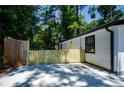Property highlighting a concrete patio for outdoor enjoyment, framed by a wooden fence for added privacy at 4244 Lindsey Dr, Decatur, GA 30035