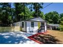 Lovely home featuring fresh exterior paint, a cozy front porch, and a well-maintained yard with mature trees at 4244 Lindsey Dr, Decatur, GA 30035