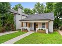Inviting single-story house featuring a cozy front porch with wooden columns and blossoming flower boxes at 995 Lena Nw St, Atlanta, GA 30314
