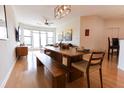 Spacious dining room with a long table, bench seating, and a modern light fixture at 400 17Th St # 2325, Atlanta, GA 30363