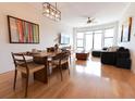 Open concept living and dining area with hardwood floors and large windows at 400 17Th St # 2325, Atlanta, GA 30363