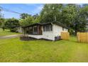 Charming renovated home with a covered carport, freshly landscaped yard, and new fence at 1553 Mccallie Nw Blvd, Atlanta, GA 30318