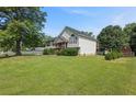 A charming two-story home with manicured lawn and mature trees, offering a serene and inviting atmosphere at 47 Powder Springs St, Hiram, GA 30141