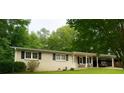Traditional home with neat landscaping, black shutters, covered porch, and car parking in a tranquil setting at 3854 Bright Star Road, Douglasville, GA 30135