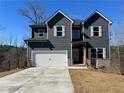 Inviting two-story home with gray siding, white trim, and a convenient two-car garage at 5443 Belle Meade Dr, Villa Rica, GA 30180