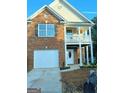 Two-story brick home with a front-facing garage and second story balcony at 6398 Shadow Sq, Lithonia, GA 30058