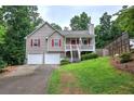 Charming home with two-car garage, covered front porch, and beautiful landscaping at 80 Broadlands Dr, White, GA 30184
