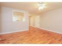 Open living room with hardwood floors and views into the kitchen at 101 Longstreet Cir, Oxford, GA 30054