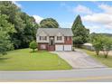 Exterior shot of a charming two-story home on a well-maintained lot with mature trees at 173 Cline Smith Ne Rd, Cartersville, GA 30121