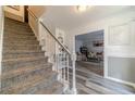Welcoming foyer featuring hardwood floors, a staircase, and views into a cozy living area, perfect for guests at 2056 Plantation Rd, Lawrenceville, GA 30044