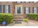 Inviting front porch with decorative pots, brick steps, and an ADT security system for added safety at 2056 Plantation Rd, Lawrenceville, GA 30044