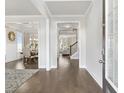 Elegant entryway with hardwood floors leading to a dining room and living area with neutral colors at 3837 Lockaby Way, Lawrenceville, GA 30044