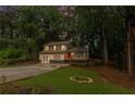A charming two-story home with a lovely front lawn at dusk at 630 Pennylake Ct, Stone Mountain, GA 30087