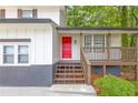 Close-up showcasing the bright red front door and inviting porch of this home at 630 Pennylake Ct, Stone Mountain, GA 30087