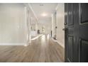 Inviting foyer with gleaming hardwood floors and views of the living spaces at 7691 Brazos Trl, Fairburn, GA 30213