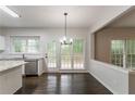 Charming dining area features stylish lighting and a view to the backyard at 1790 Abinger Ln, Lawrenceville, GA 30043