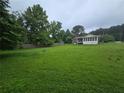 Expansive backyard with plenty of green space and a screened-in porch at 1997 Villa Rica Hwy, Dallas, GA 30157