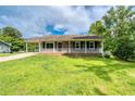 This single-story home features a covered porch and a well-kept lawn at 1997 Villa Rica Hwy, Dallas, GA 30157