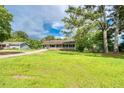 A cozy single-story home featuring a covered porch and a lush green lawn at 1997 Villa Rica Hwy, Dallas, GA 30157