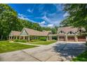 Charming home with a well-manicured lawn, stone accents, and a matching garage building at 2680 Bay Ridge Dr, Loganville, GA 30052