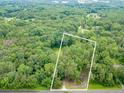 Expansive aerial view showcasing a large, heavily wooded lot, outlined in white at 3329 Walt Stephens Rd, Stockbridge, GA 30281