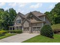 Beautiful house with a two car garage, a covered porch, and mature landscaping at 4120 Abingdon, Cumming, GA 30041