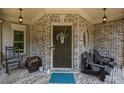 Inviting front porch with brick facade, seating, and charming decorative touches at 4120 Abingdon, Cumming, GA 30041