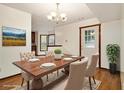 Bright dining room with modern chandelier and large doorway to other rooms of the house at 4214 Fiddlers Bnd, Loganville, GA 30052