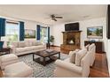 Bright living room with brick fireplace, large windows, and hardwood floors creates a cozy atmosphere at 4214 Fiddlers Bnd, Loganville, GA 30052