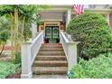 Inviting front porch featuring a brick staircase, white railings, and a charming entrance at 4770 Spring Park Cir, Suwanee, GA 30024