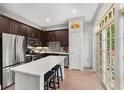 Modern kitchen boasts stainless steel appliances, dark cabinetry, quartz countertop island, and outdoor access at 1055 Piedmont Ne Ave # 106, Atlanta, GA 30309