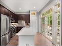 A view of the kitchen featuring an island, stainless steel appliances, and a sliding glass door at 1055 Piedmont Ne Ave # 106, Atlanta, GA 30309