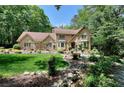 Charming brick two-story home with lush landscaping and a welcoming walkway at 4853 Carlene Sw Way, Lilburn, GA 30047