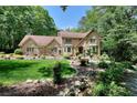 Charming brick home with well-manicured lawn and landscaping, nestled among mature trees at 4853 Carlene Sw Way, Lilburn, GA 30047