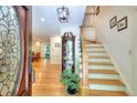 Inviting foyer with hardwood floors, staircase, and elegant glass-paneled front door at 4853 Carlene Sw Way, Lilburn, GA 30047
